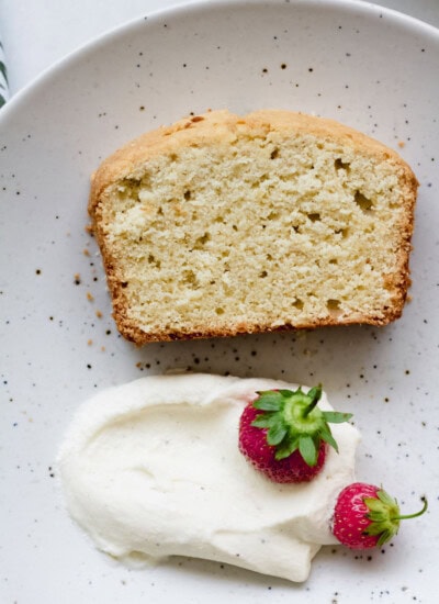 slice of gluten free pound cake with whipped cream and strawberries