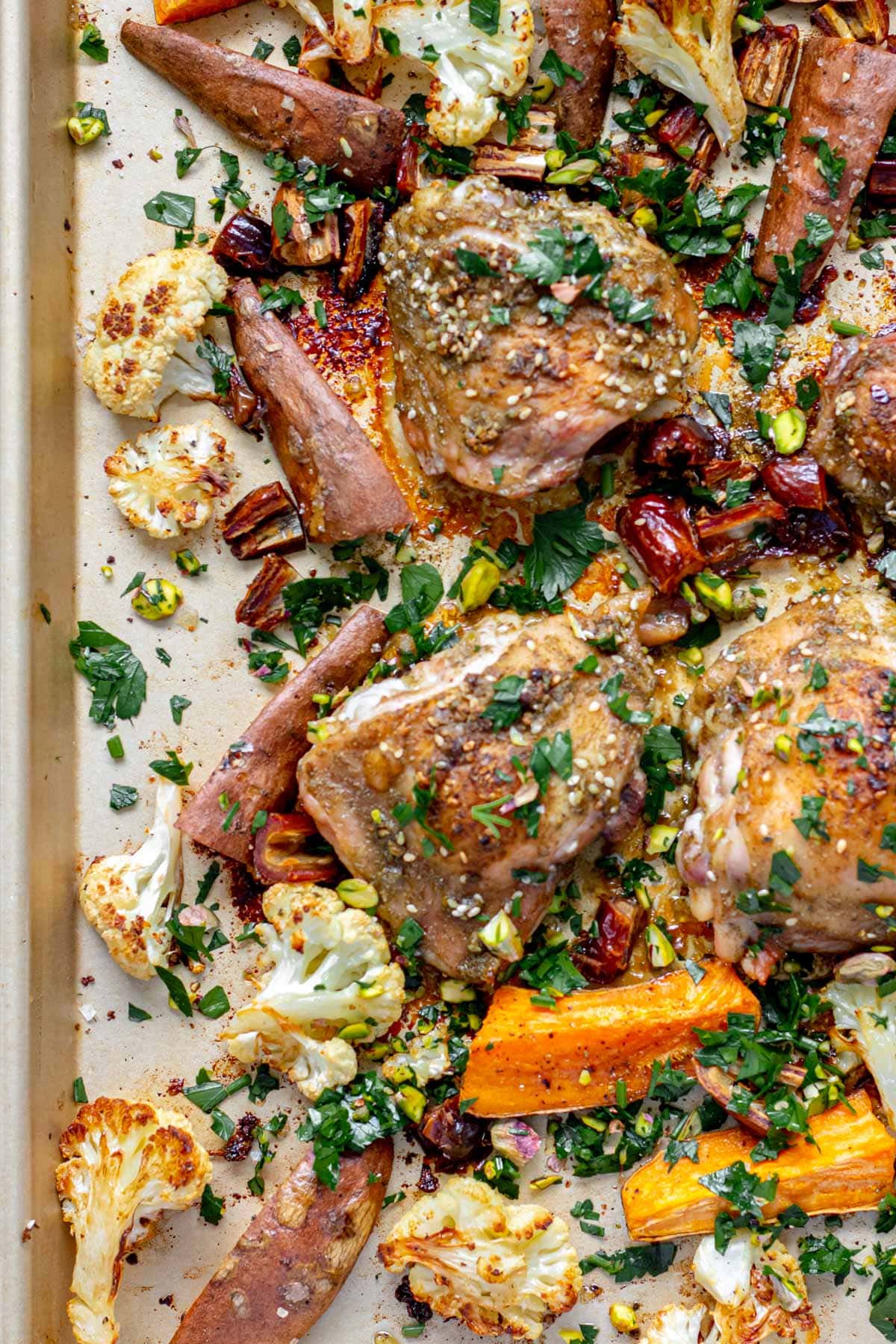 a sheet pan of spiced za'atar roasted chicken with sweet potatoes and cauliflower