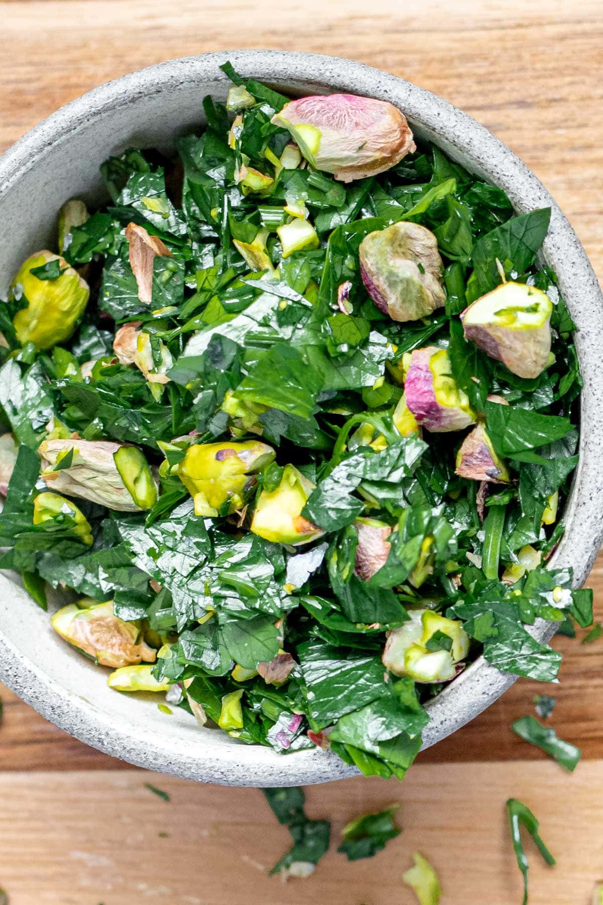 a small bowl of parsley and pistachios