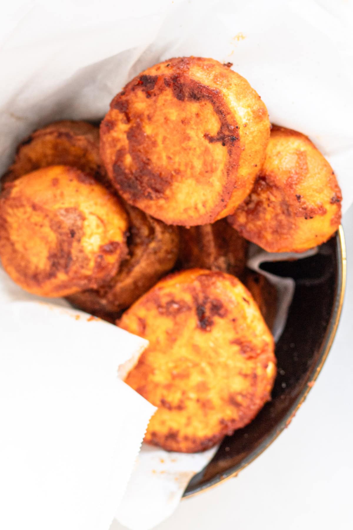 sliced and spiced sweet potato rounds in a bowl