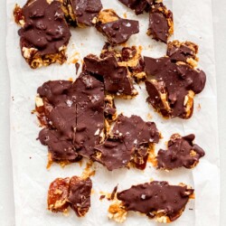 crinkled parchment paper with chocolate date bark cracked on top