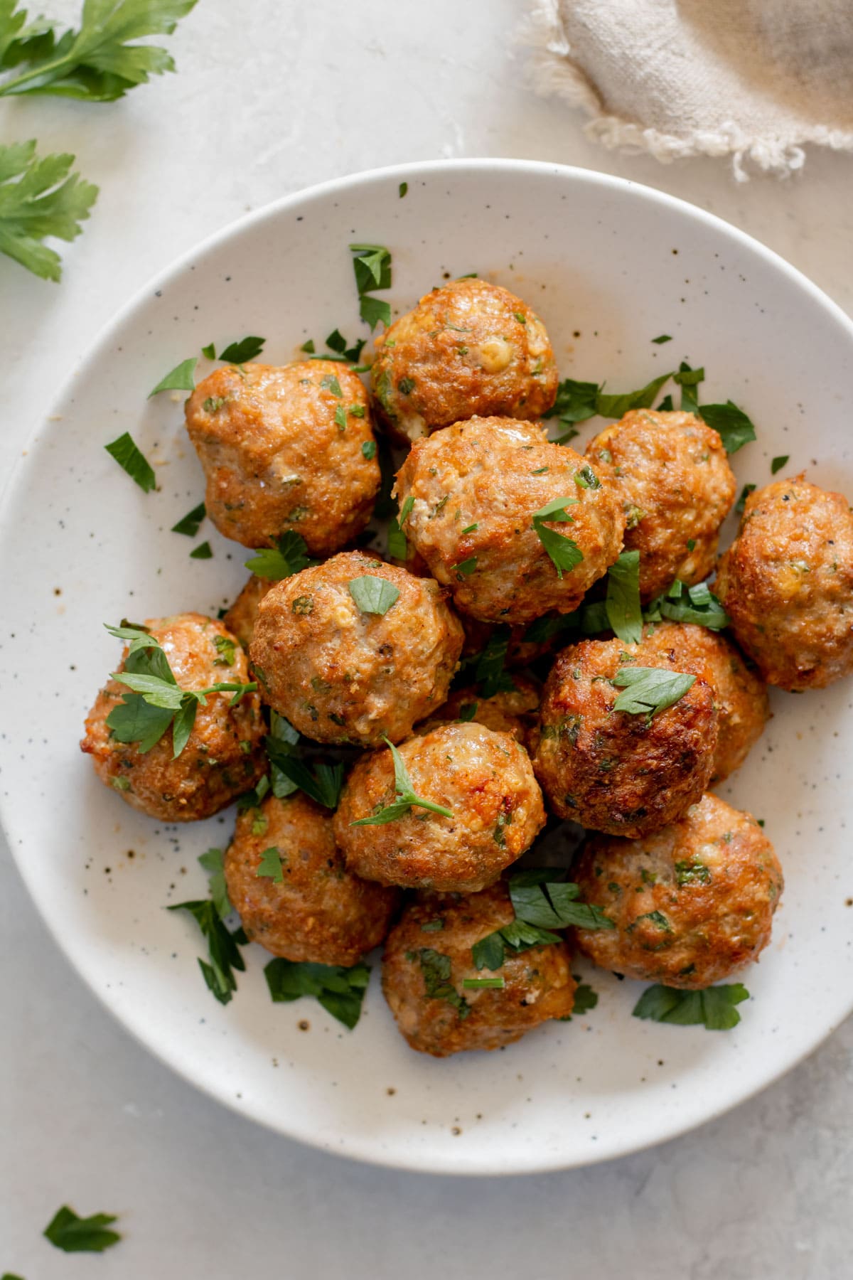 plate of air fryer turkey meatballs with fresh parsley on top