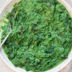 white serving bowl with creamed kale and spinach