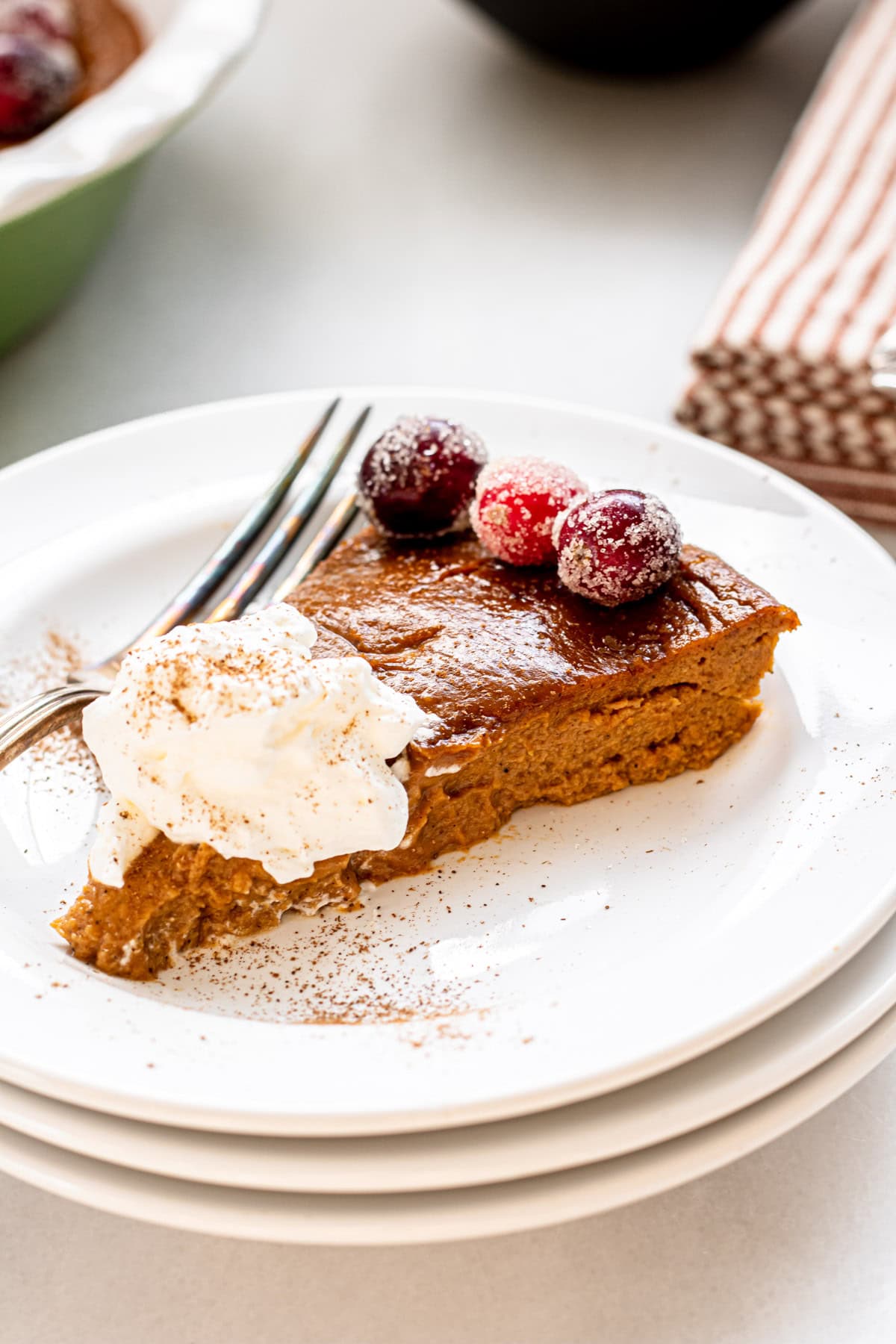 a slice of pumpkin pie with whipped cream