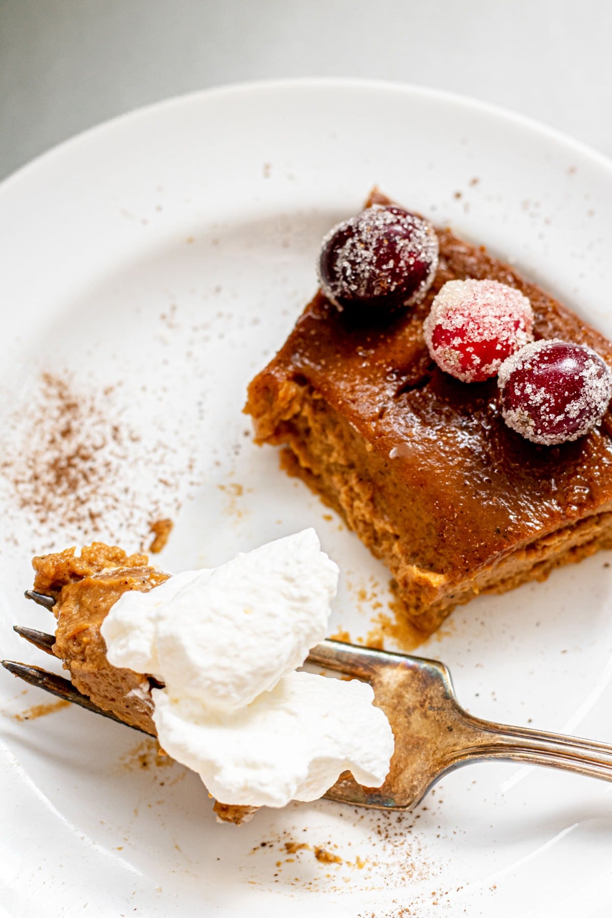 a slice of pumpkin pie with whipped cream