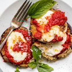 close up shot of gluten free eggplant parmesan with a fork resting on the plate