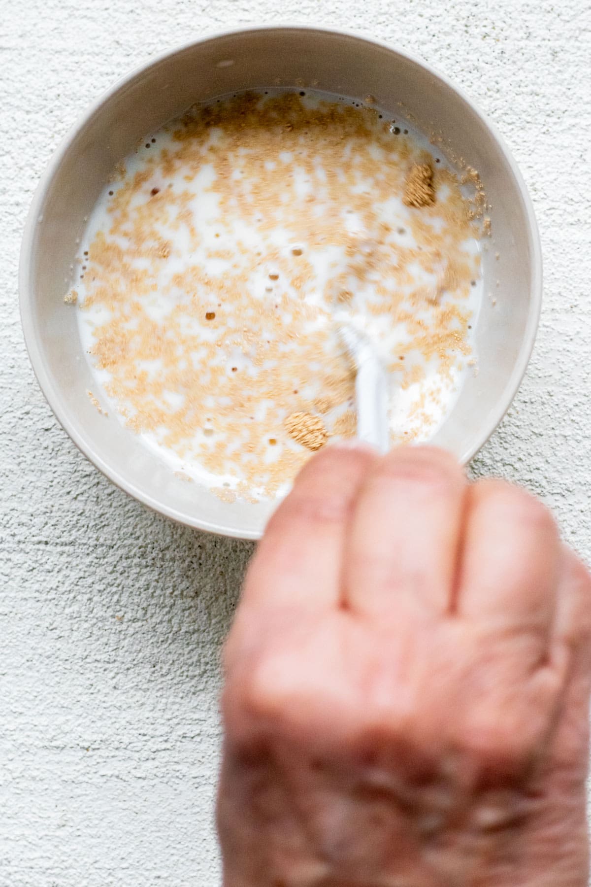 stirring yeast into milk