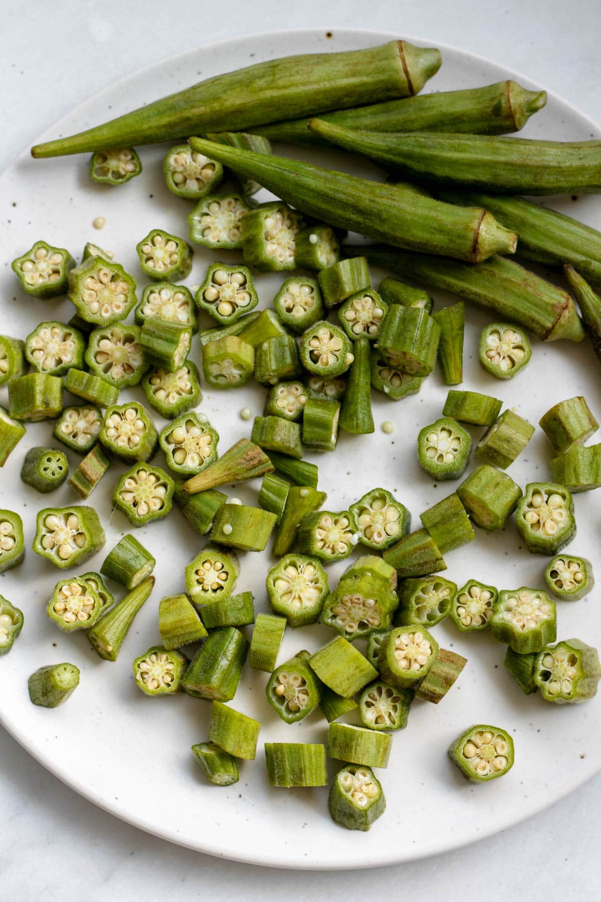 sliced okra on a white background