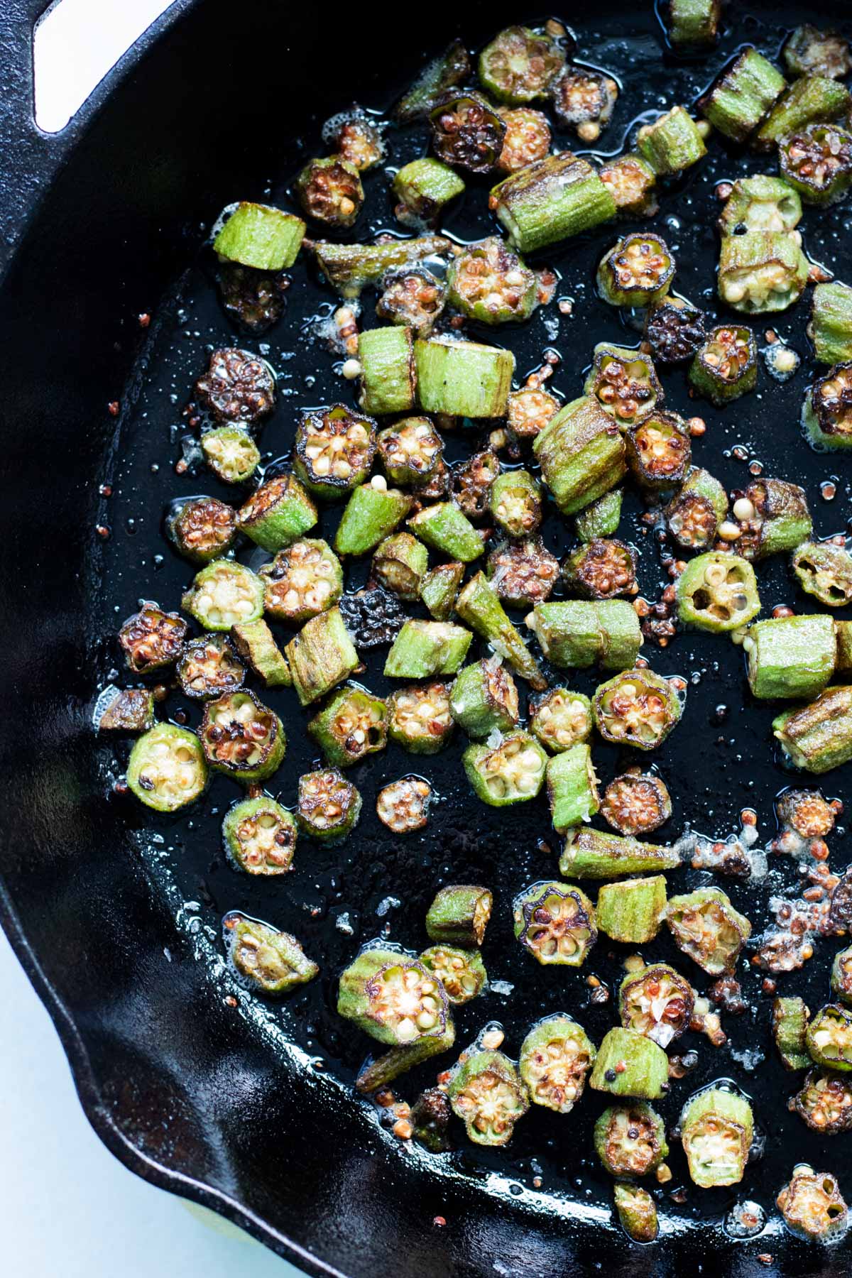 crispy pan fried okra in a large cast iron skillet