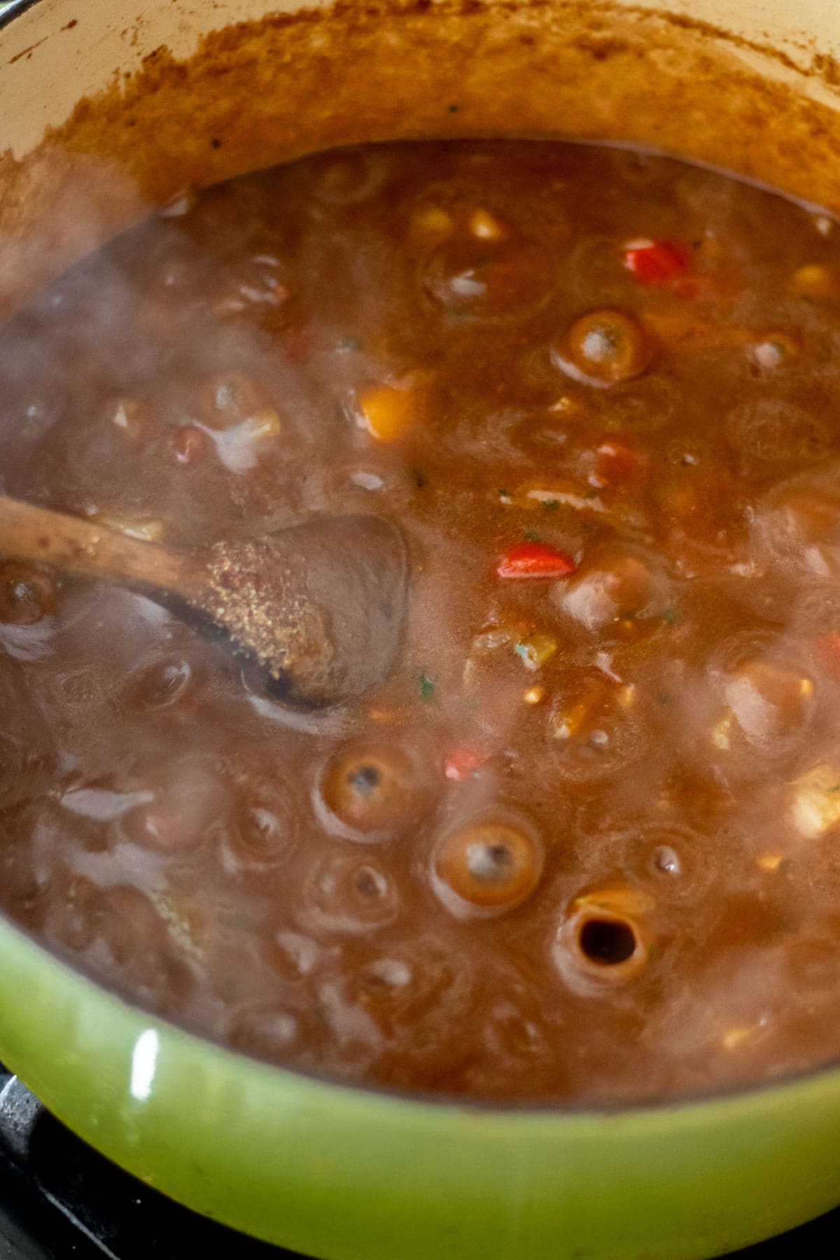 dark roux from gumbo bubbling away in a large pot