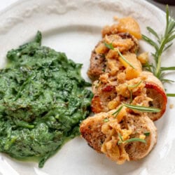 pork medallions on a plate with apple chutney and creamed greens