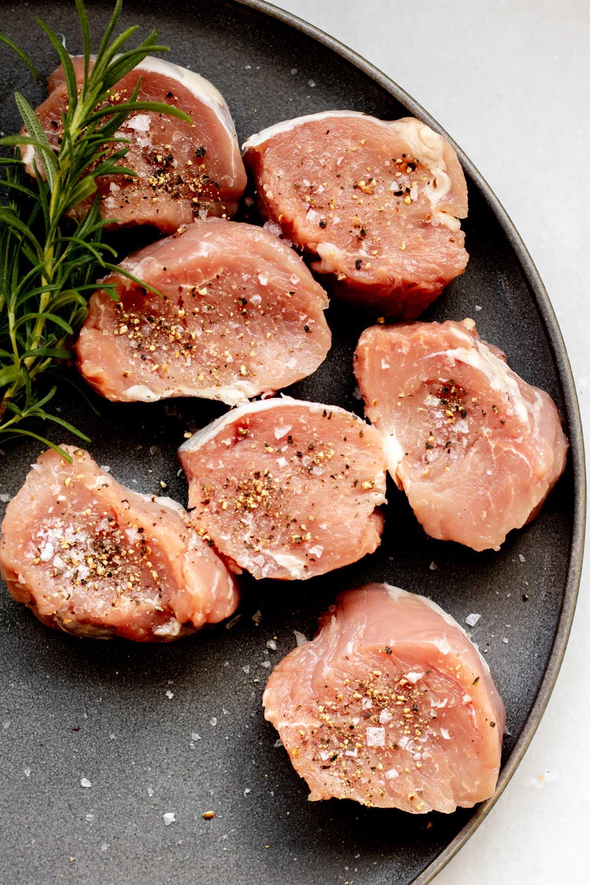 seasoned pork medallions ready to be pan seared