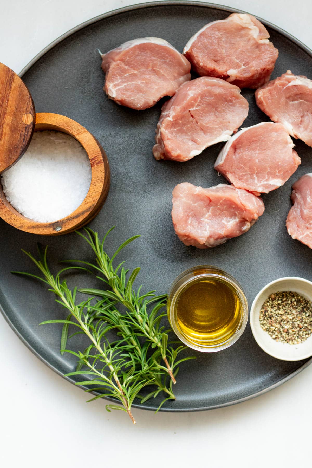 Ingredients on a grey platter to make easy pork medallions