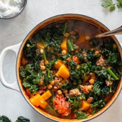 a pot of ground lamb stew with a ladle in it