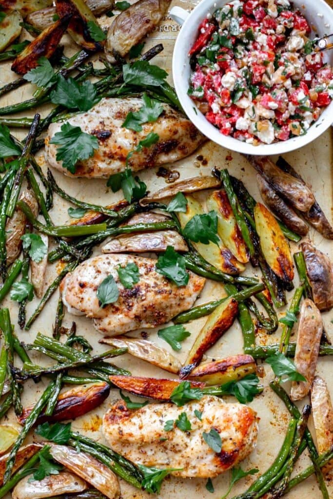 A sheet pan with chicken, asparagus and potatoes.