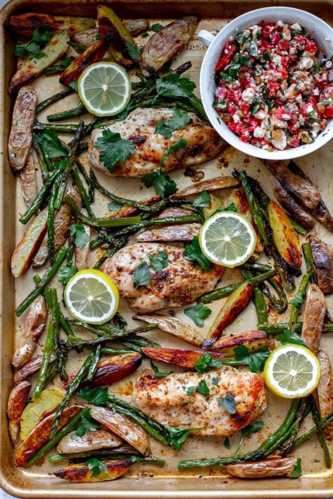 A sheet pan with chicken, asparagus and potatoes.