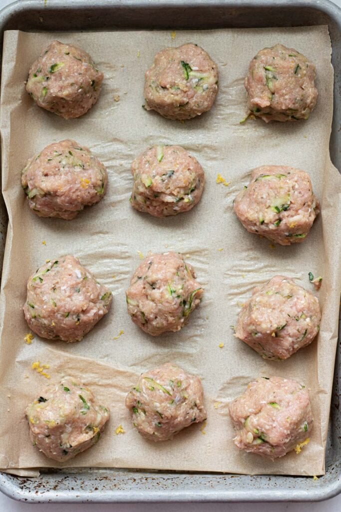 sheet tray of turkey zucchini meatballs before they are baked in the oven