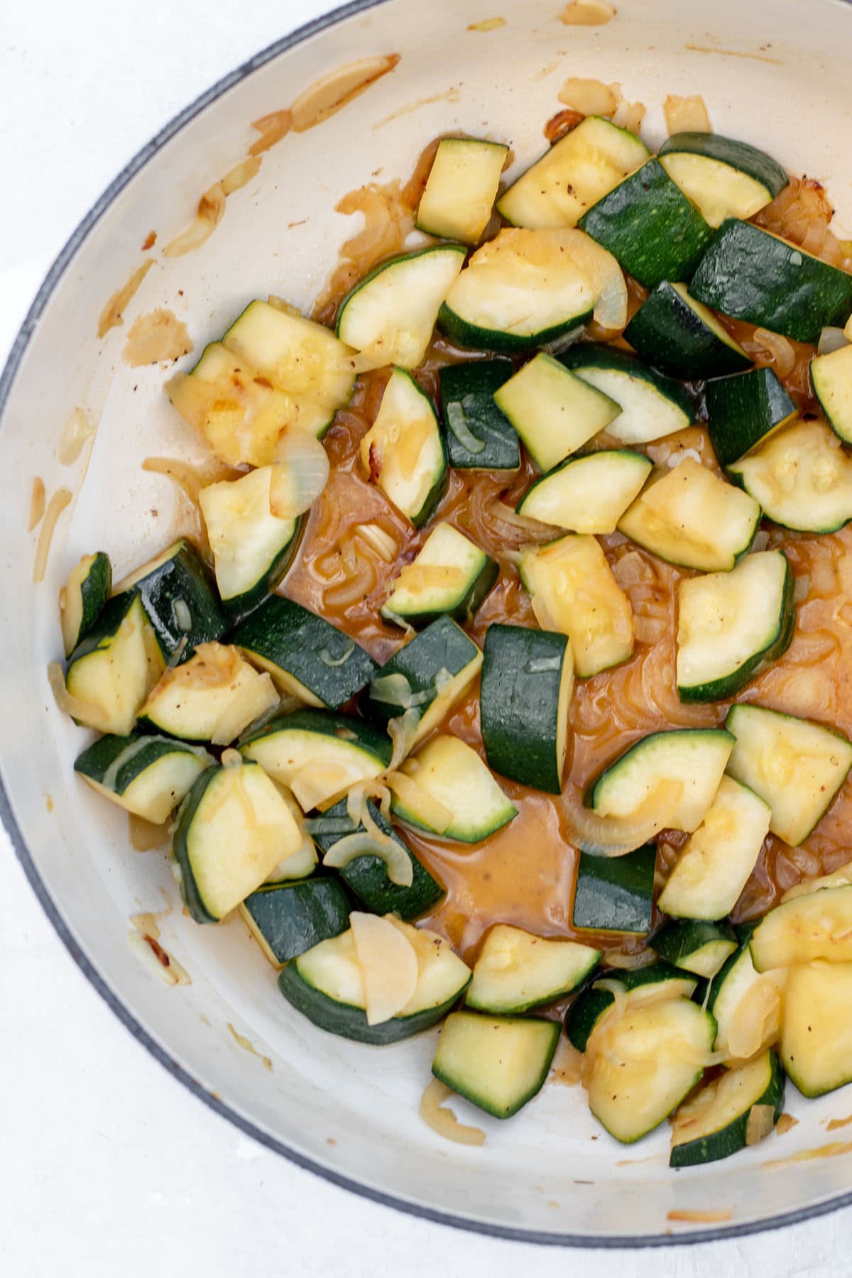 pot with onions, garlic, and zucchini