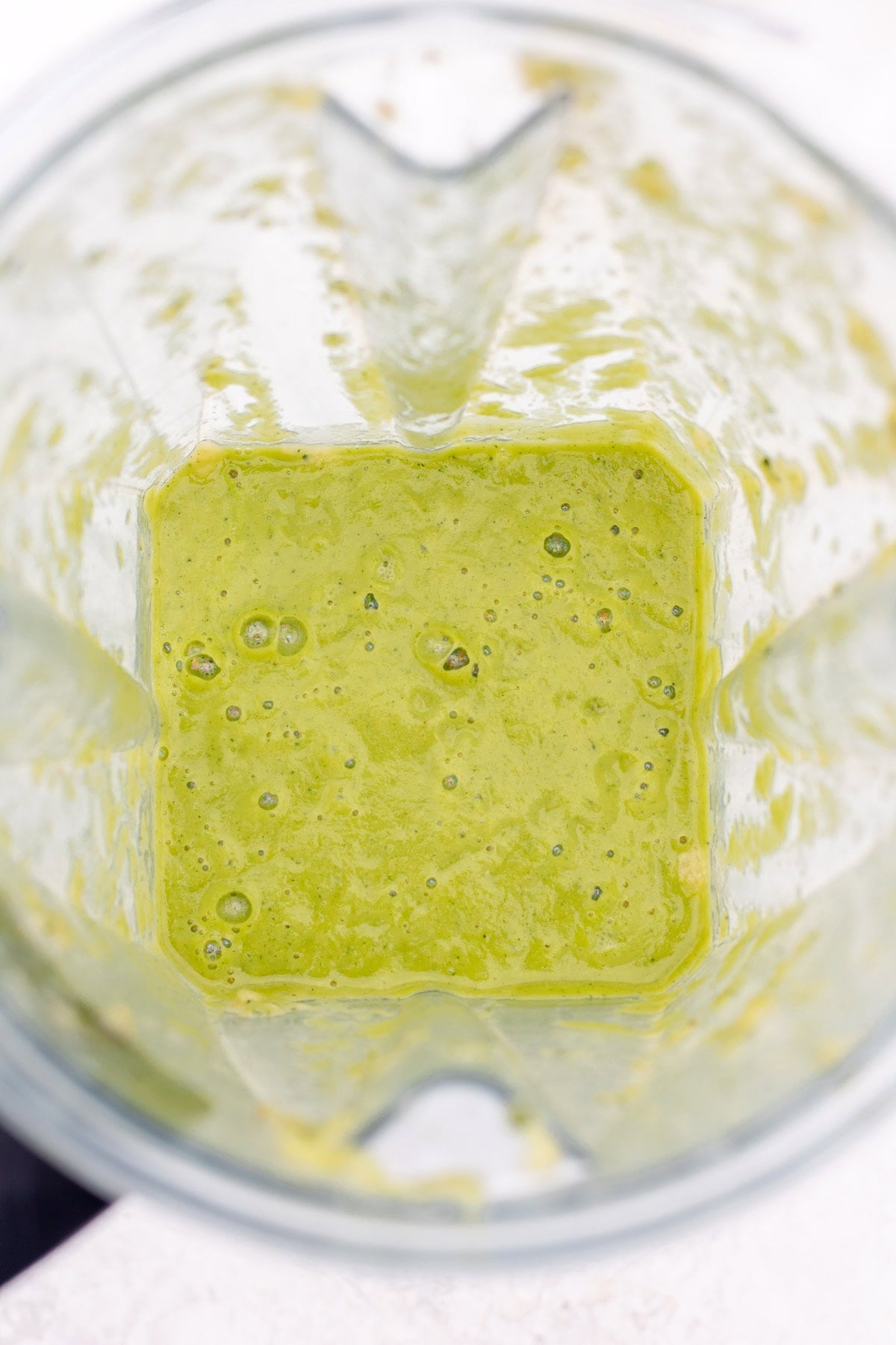 blender with green creamy zucchini sauce
