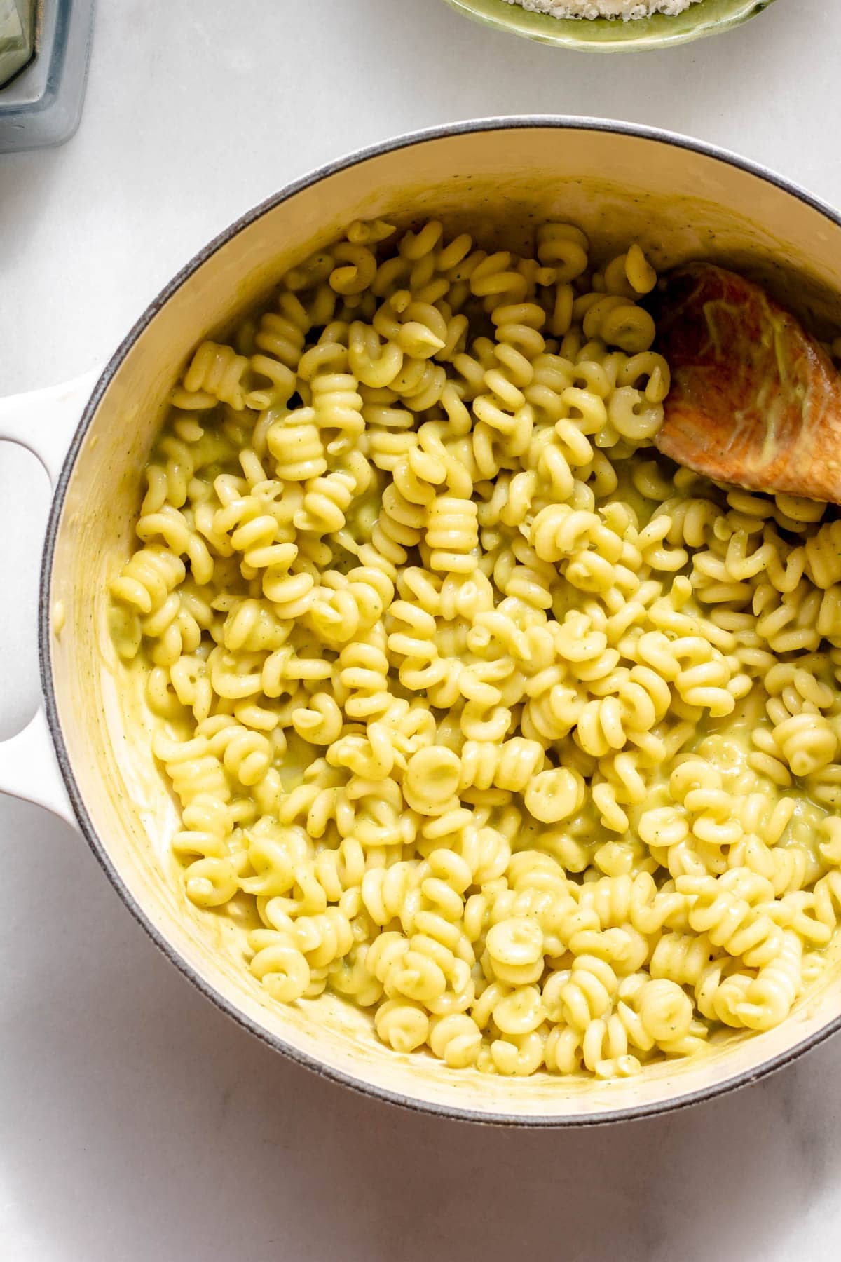 spoon in pot of creamy zucchini pasta