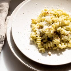 white plate with creamy zucchini pasta