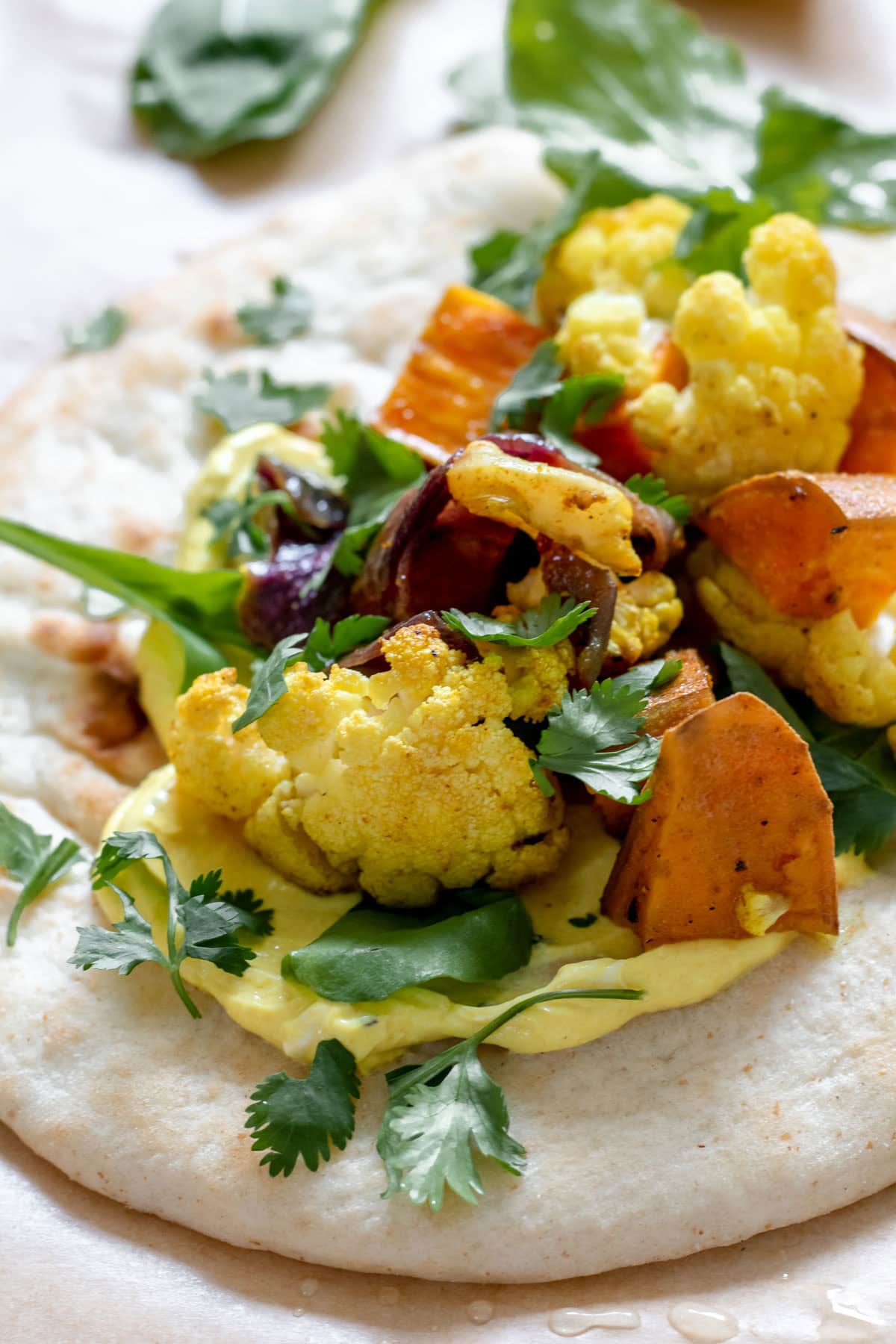 pita stuffed with veggies and turmeric yogurt sauce