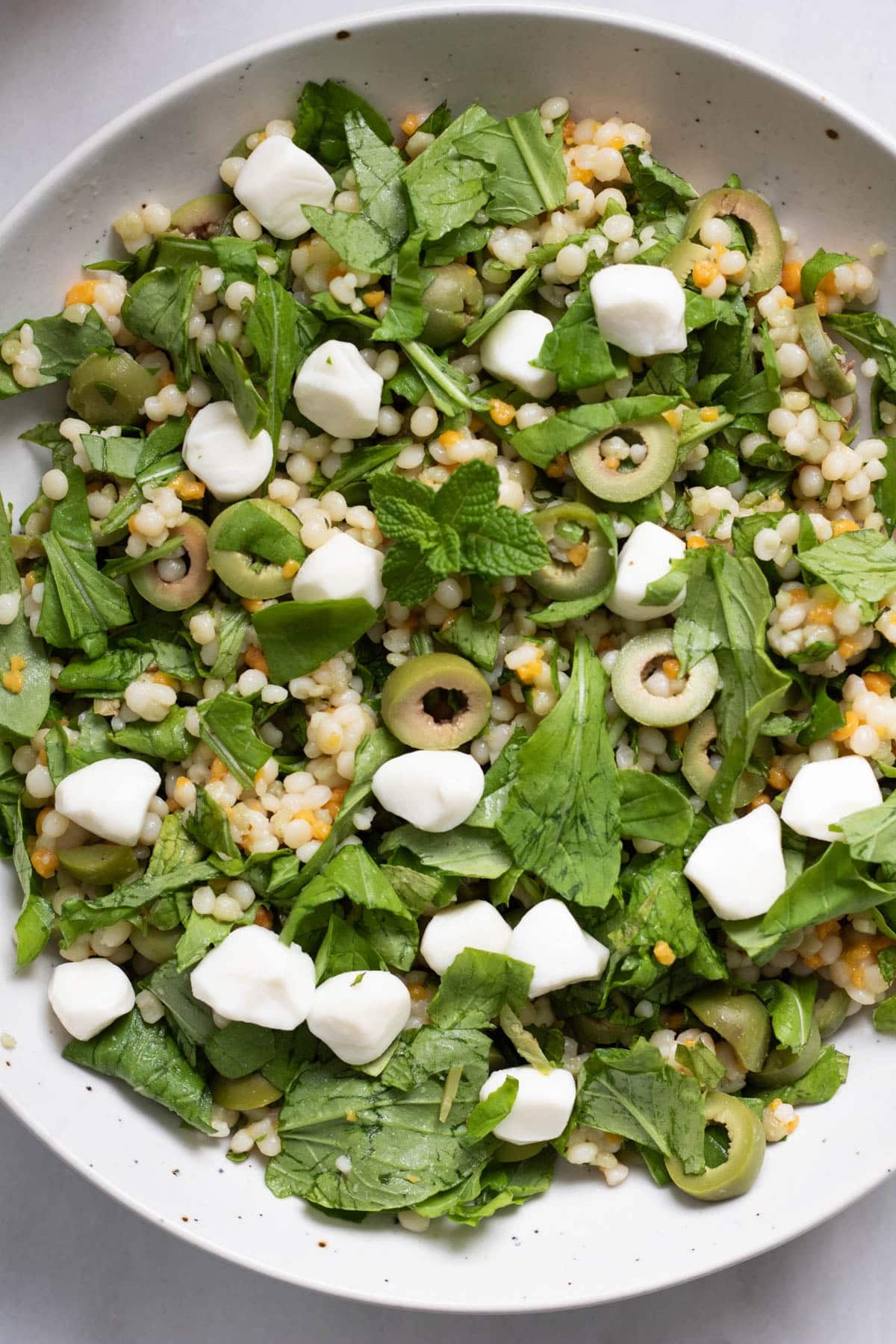 Olive CousCous Salad in a white bowl