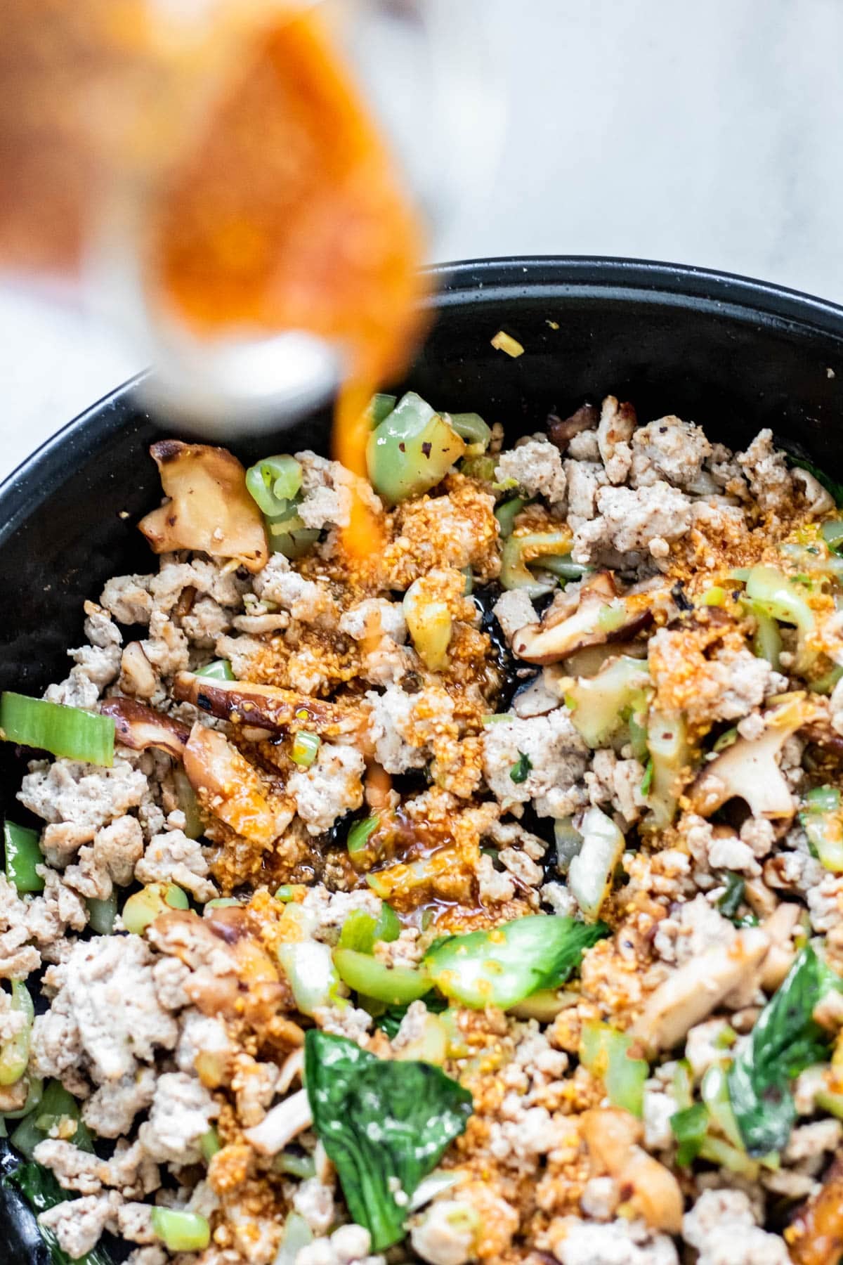 bok choy and ground turkey in saute pan