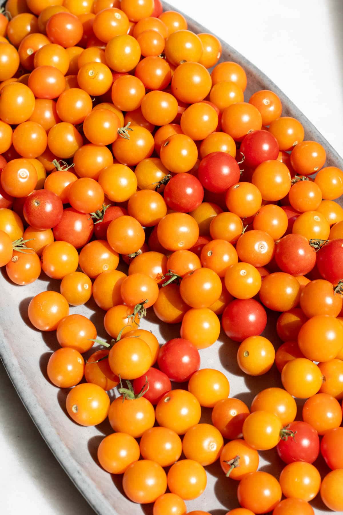 a platter of sungold tomatoes