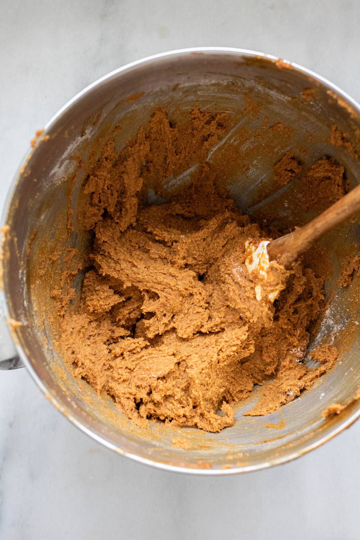 molasses cookie dough in mixer bowl