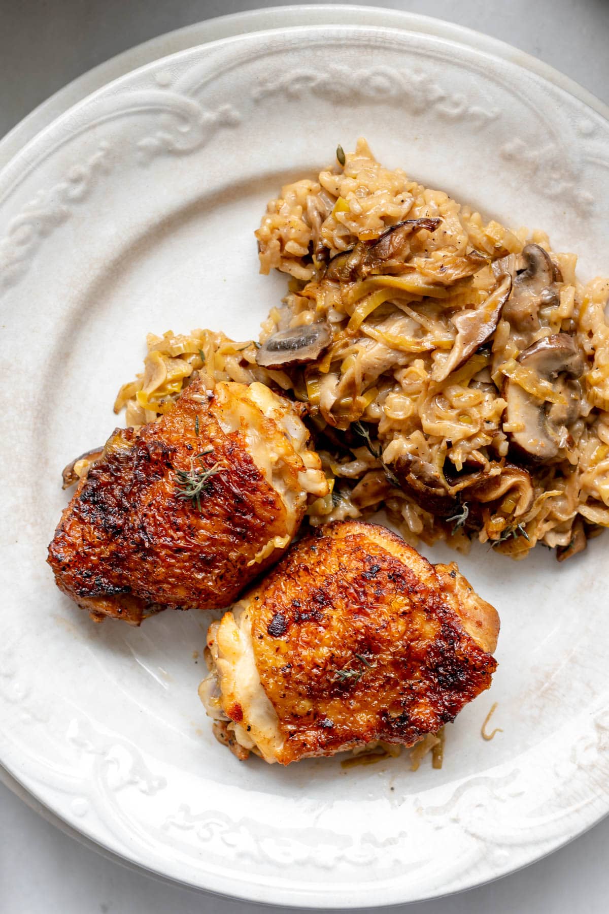 mushroom leek chicken and rice in a white plate