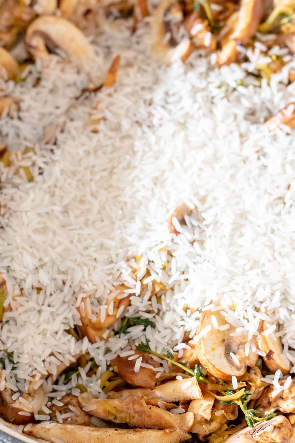 adding rice to mushroom and leeks