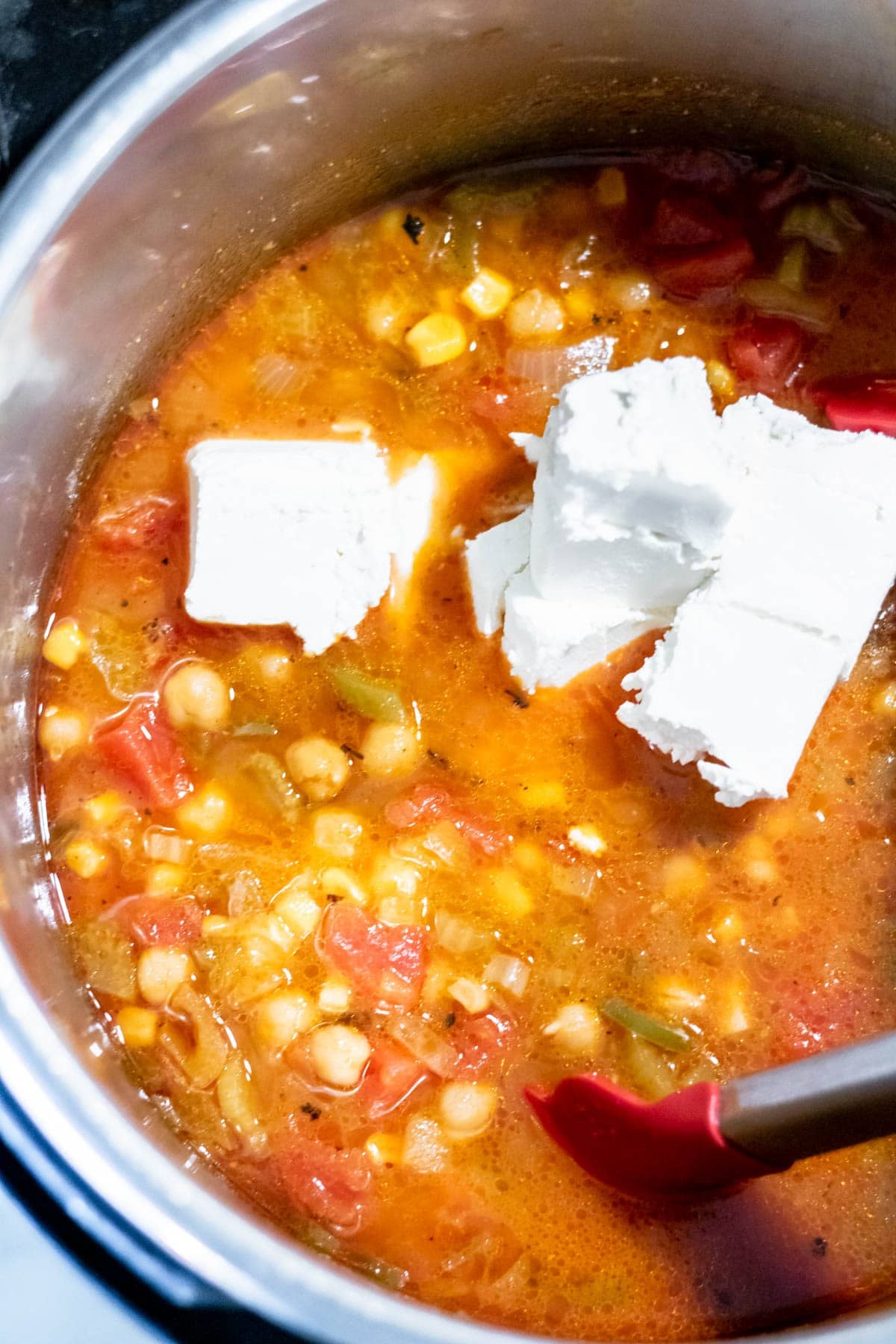 cream cheese bits in a pot of chili