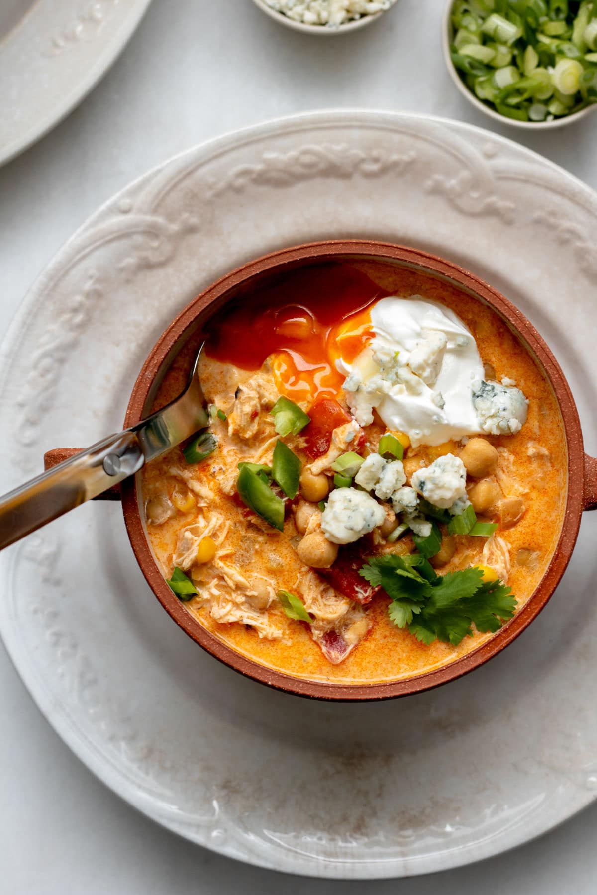 Buffalo Chicken Chili in a brown bowl on a white plate
