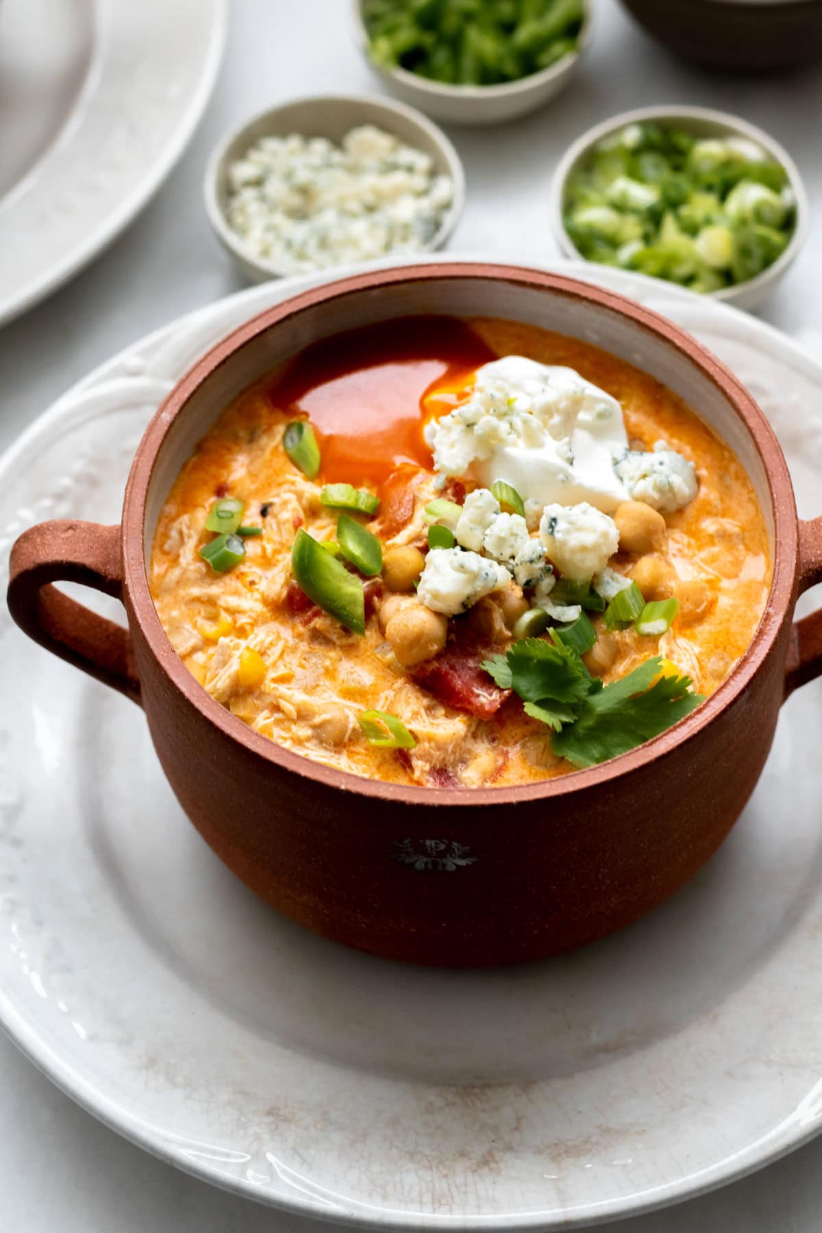 Buffalo Chicken Chili in a brown bowl on a white plate