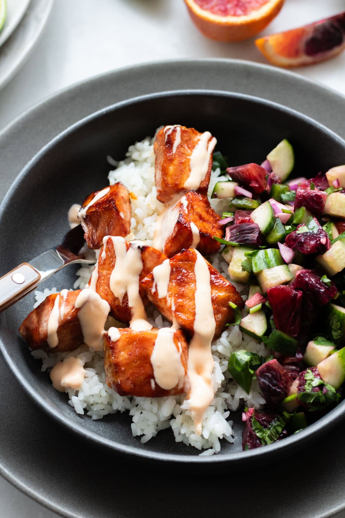 close up of hot honey salmon bowl with bang bang sauce drizzle