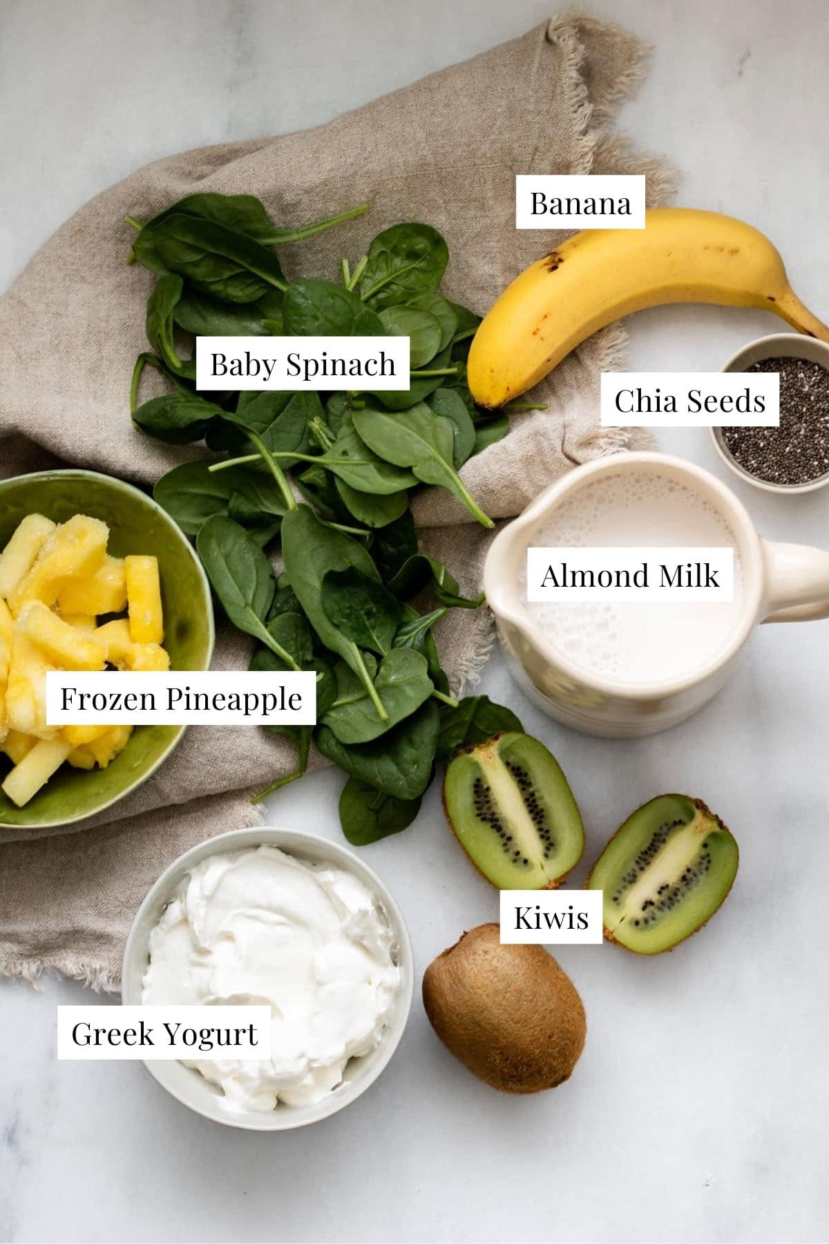 ingredients needed for tropical kiwi smoothie on a beige cloth