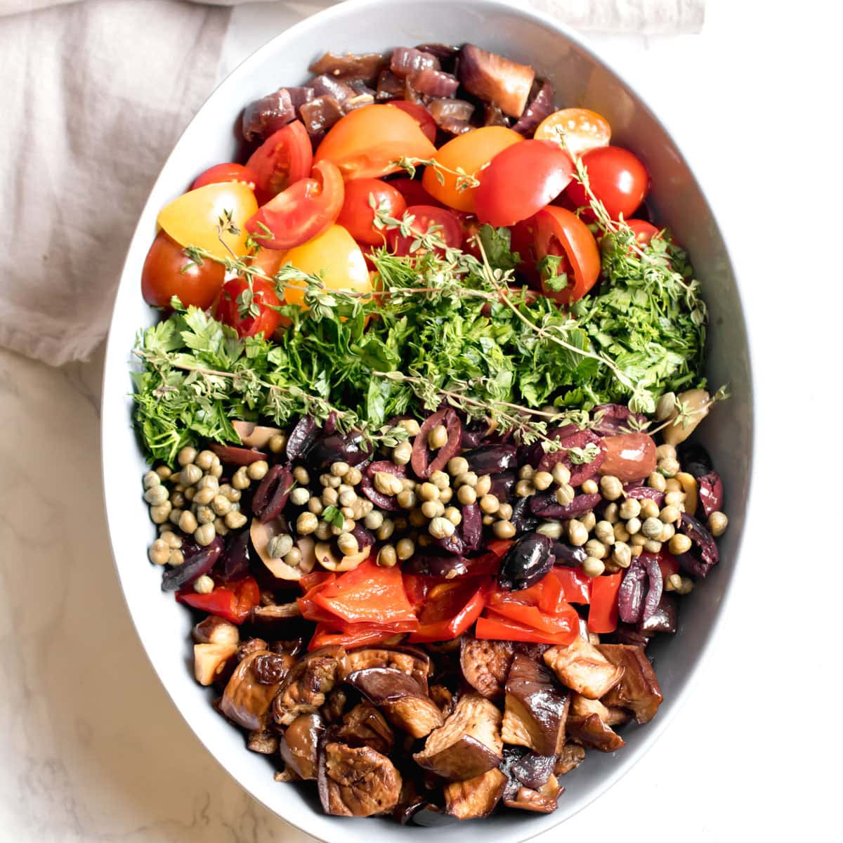 ingredients for farro salad packed neatly next to each other in a serving bowl