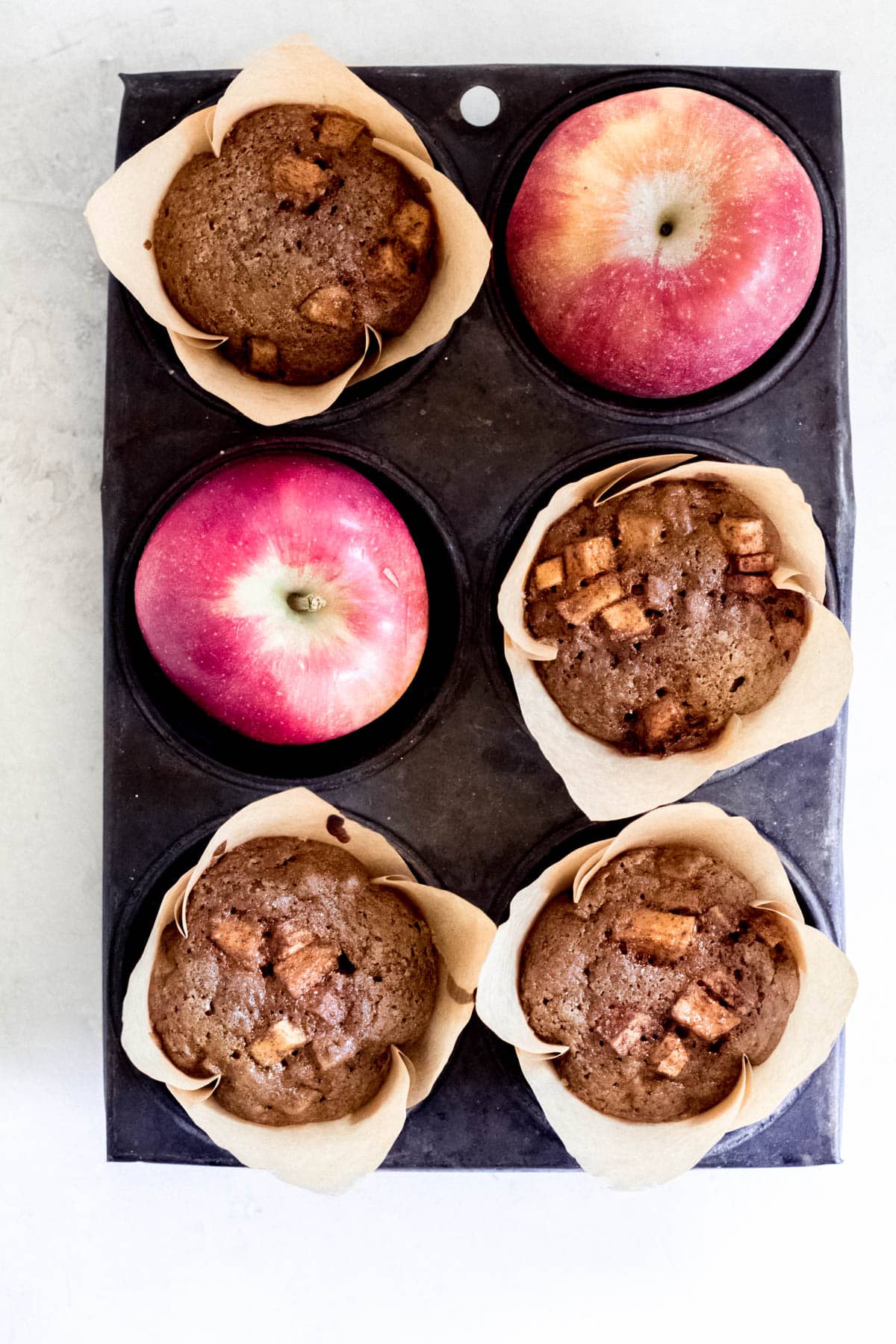 baked apple muffins in a muffin tin