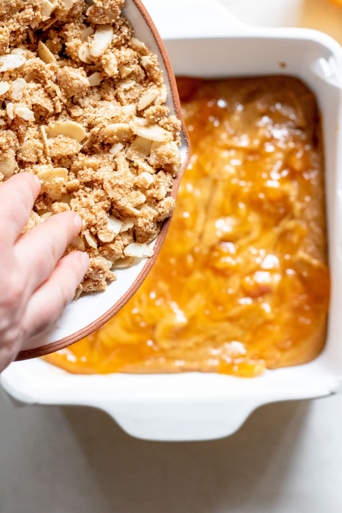 adding crumble on top of cake dough