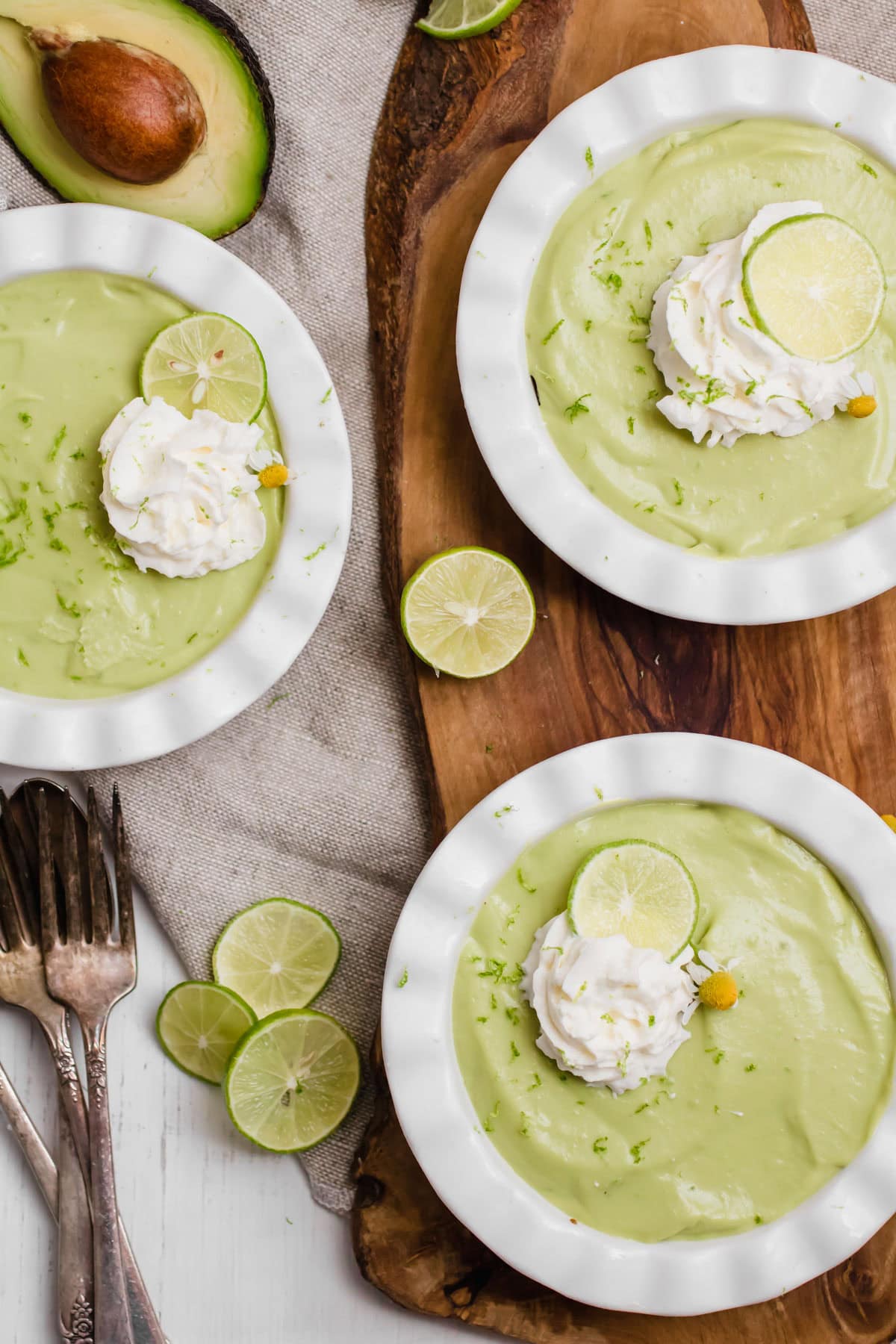 3 plates of avocado key lime pie with whipped cream