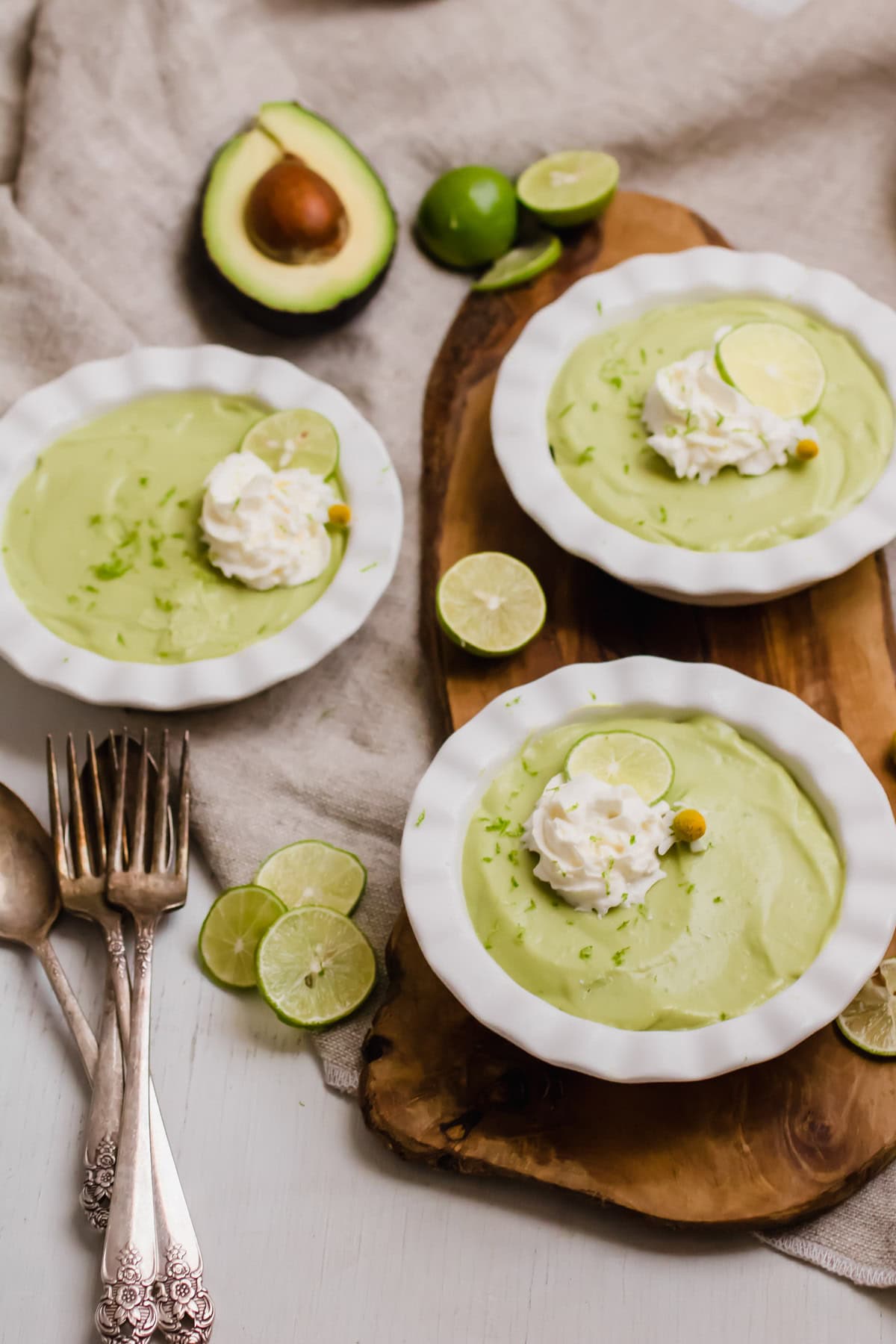 3 plates of avocado key lime pie with whipped cream