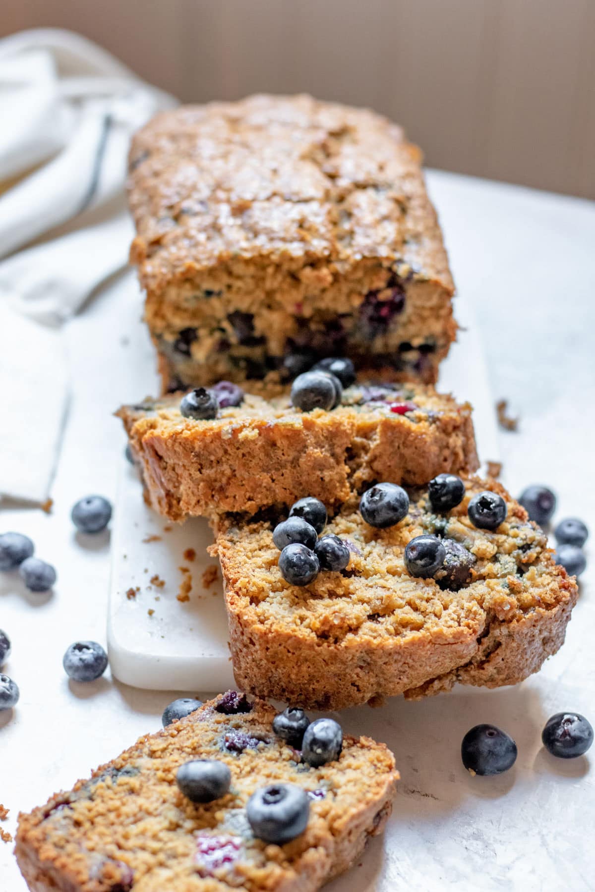 slices of blueberry banana bread with fresh blueberries on top