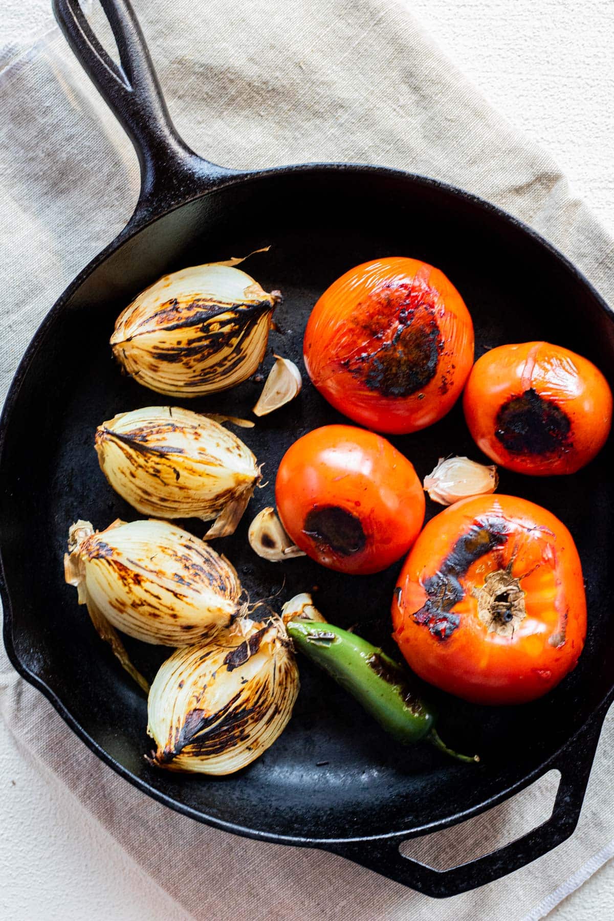 charred vegetables in a cast iron pan
