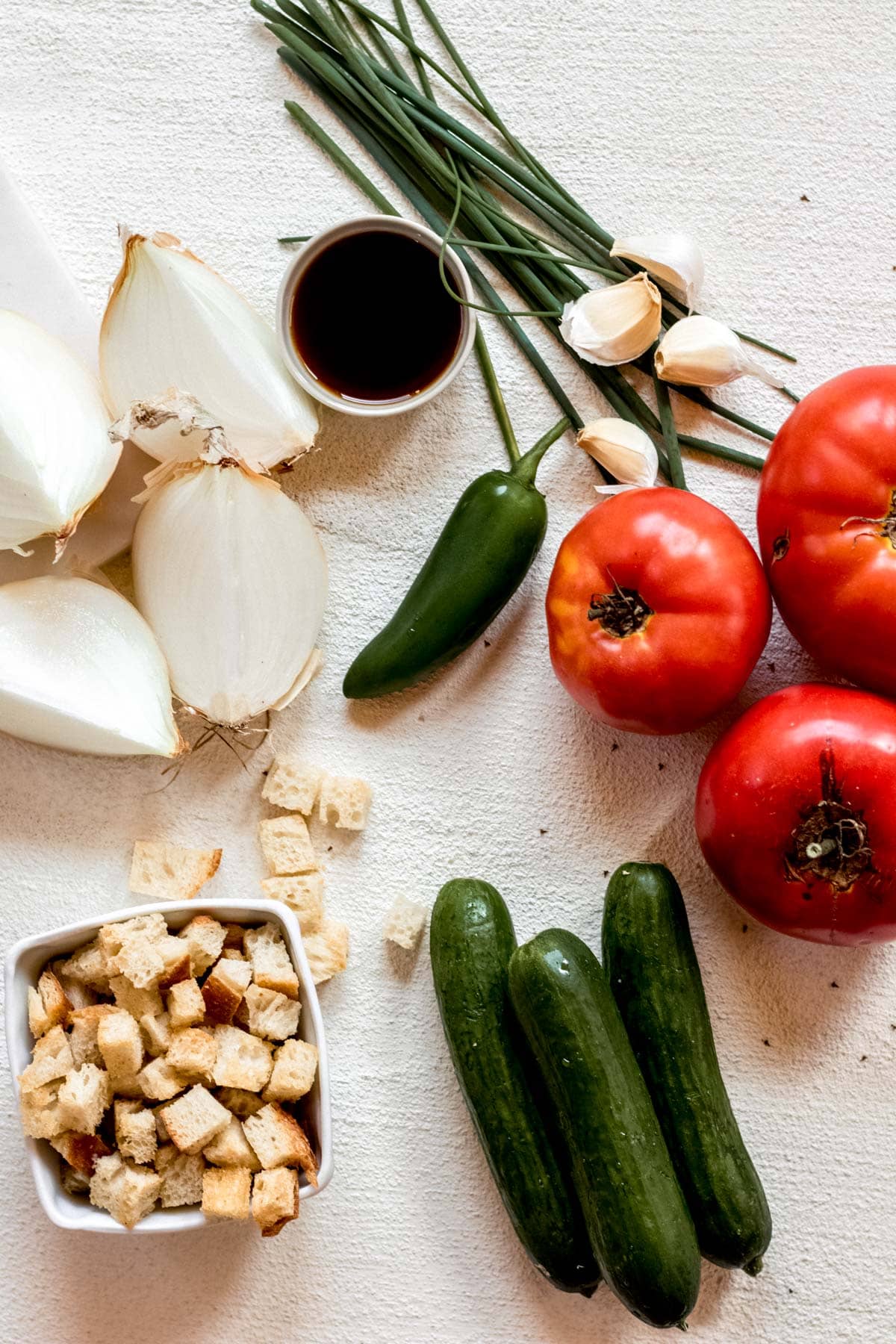 ingredients for gazpacho soup on a white table