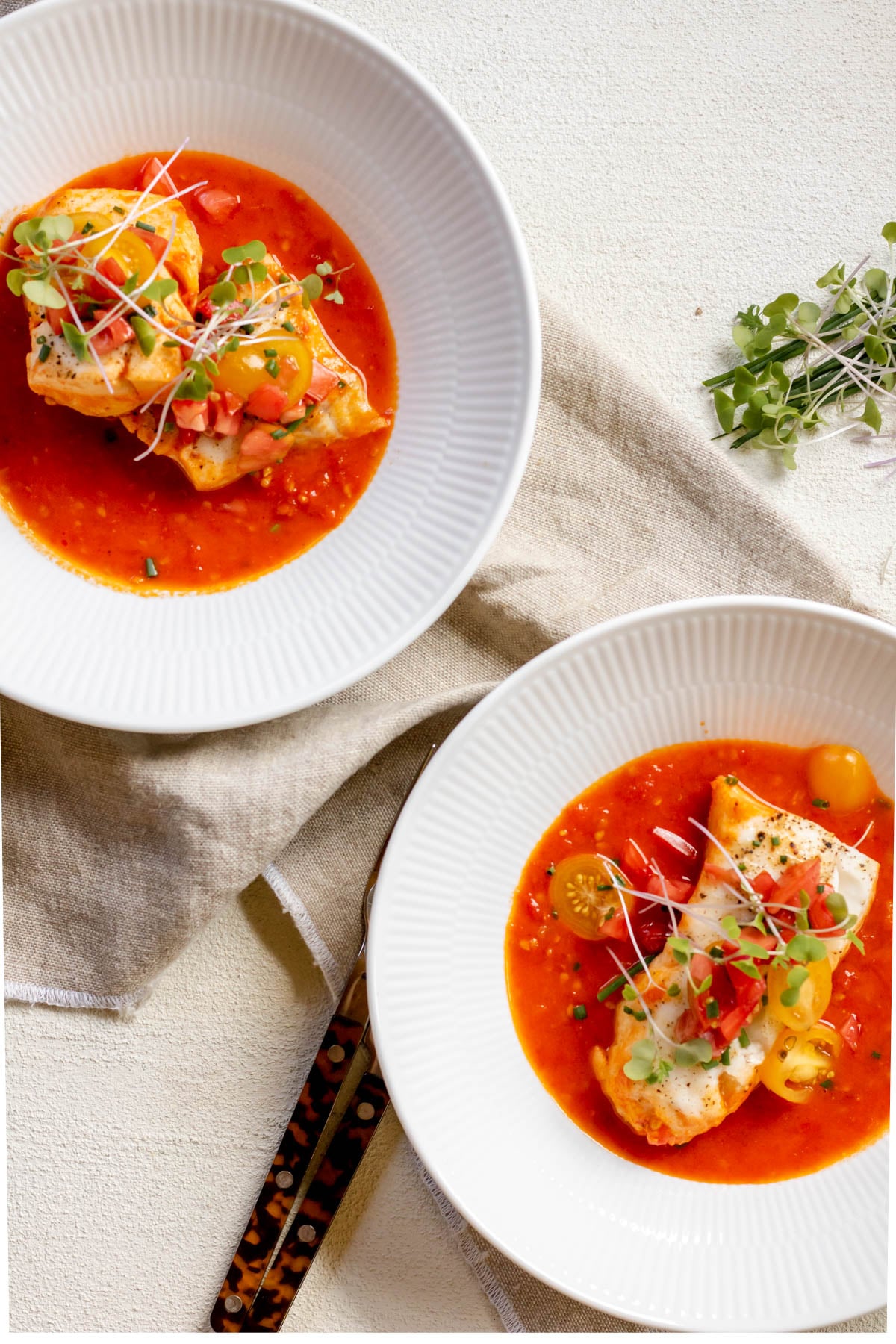 two plates of One Pan Cod in Tomato Butter Sauce