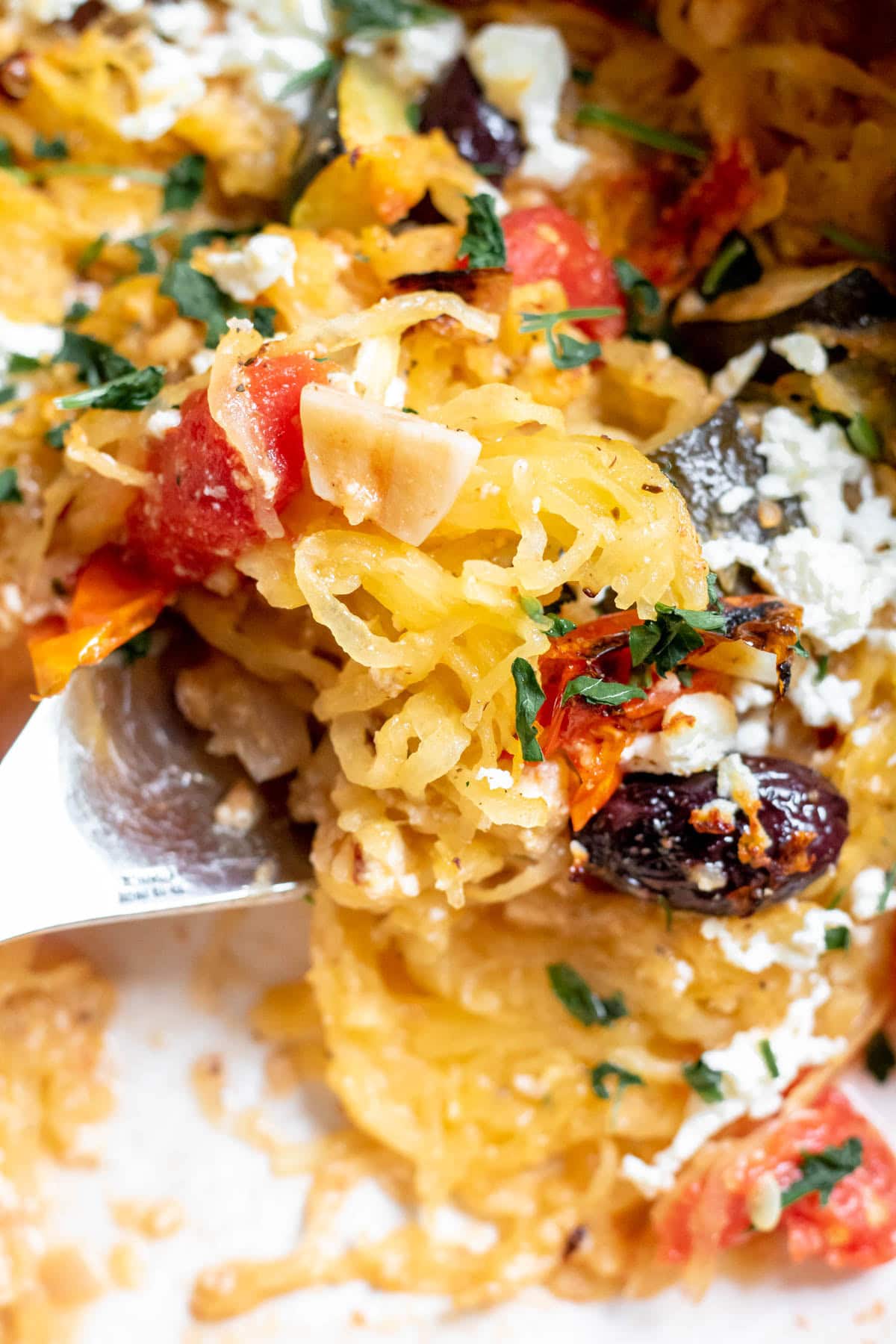 close up of Baked Feta and Olive Spaghetti Squash in a baking dish