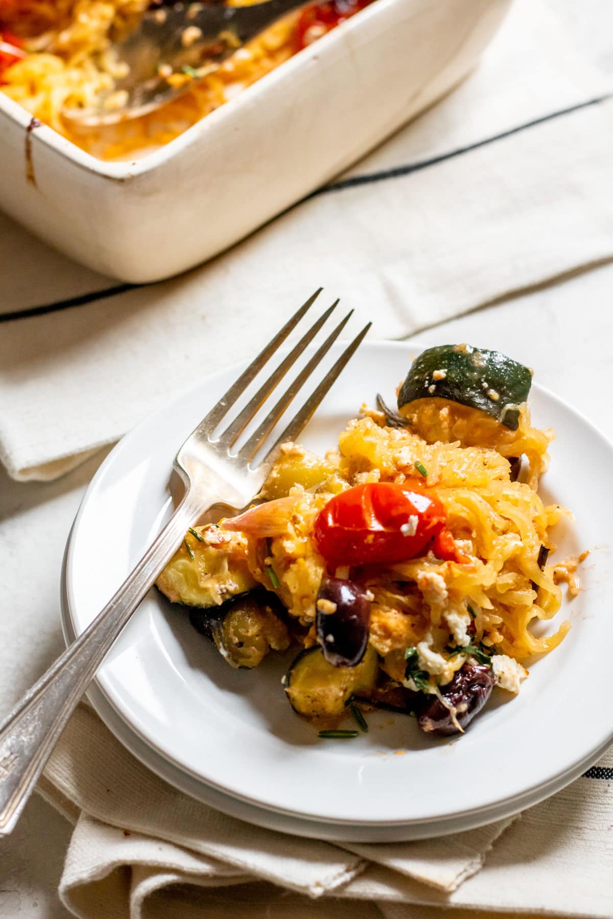 a serving of Baked Feta and Olive Spaghetti Squash on a white plate