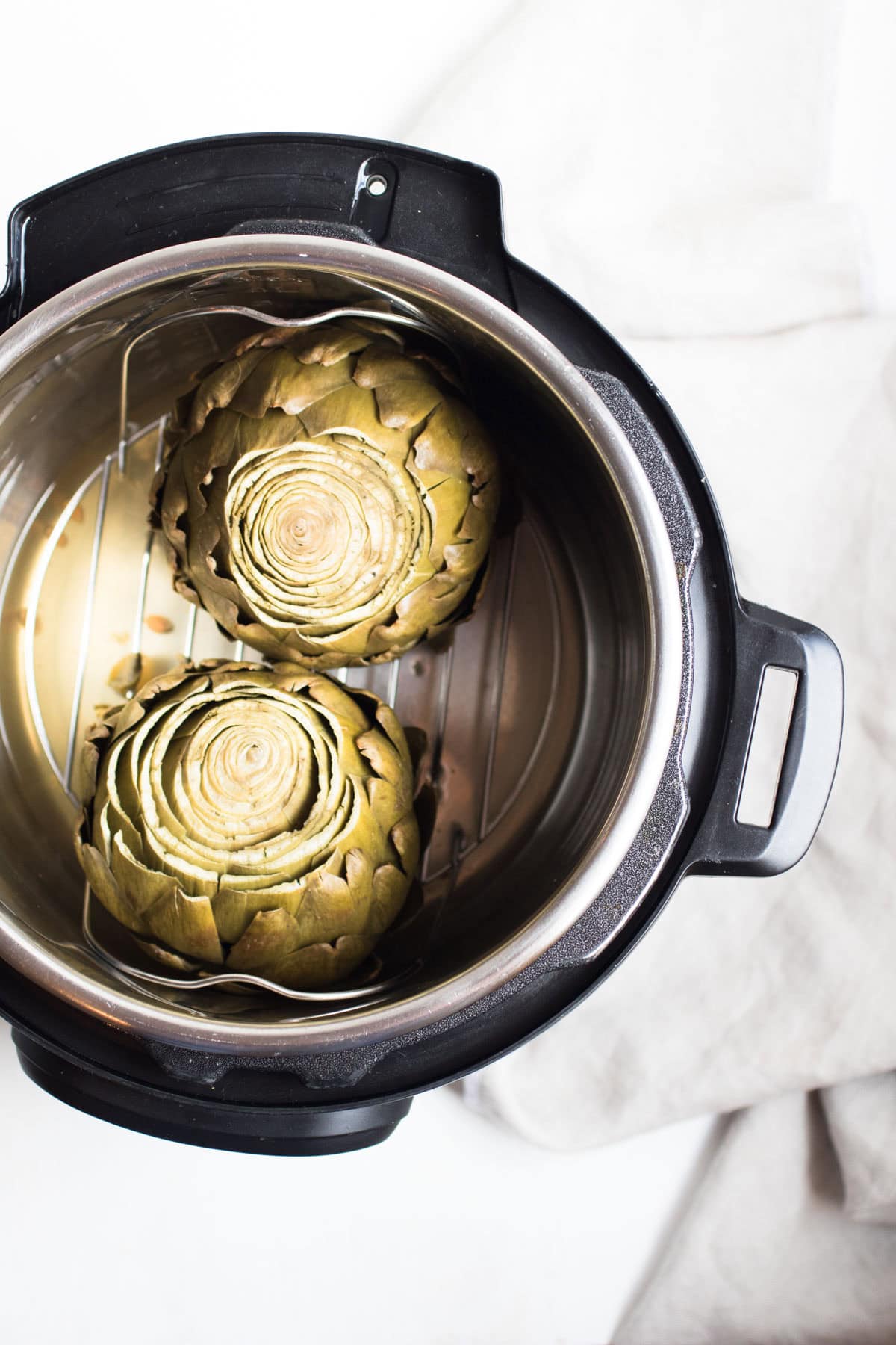 top down view of whole artichokes in an instant pot