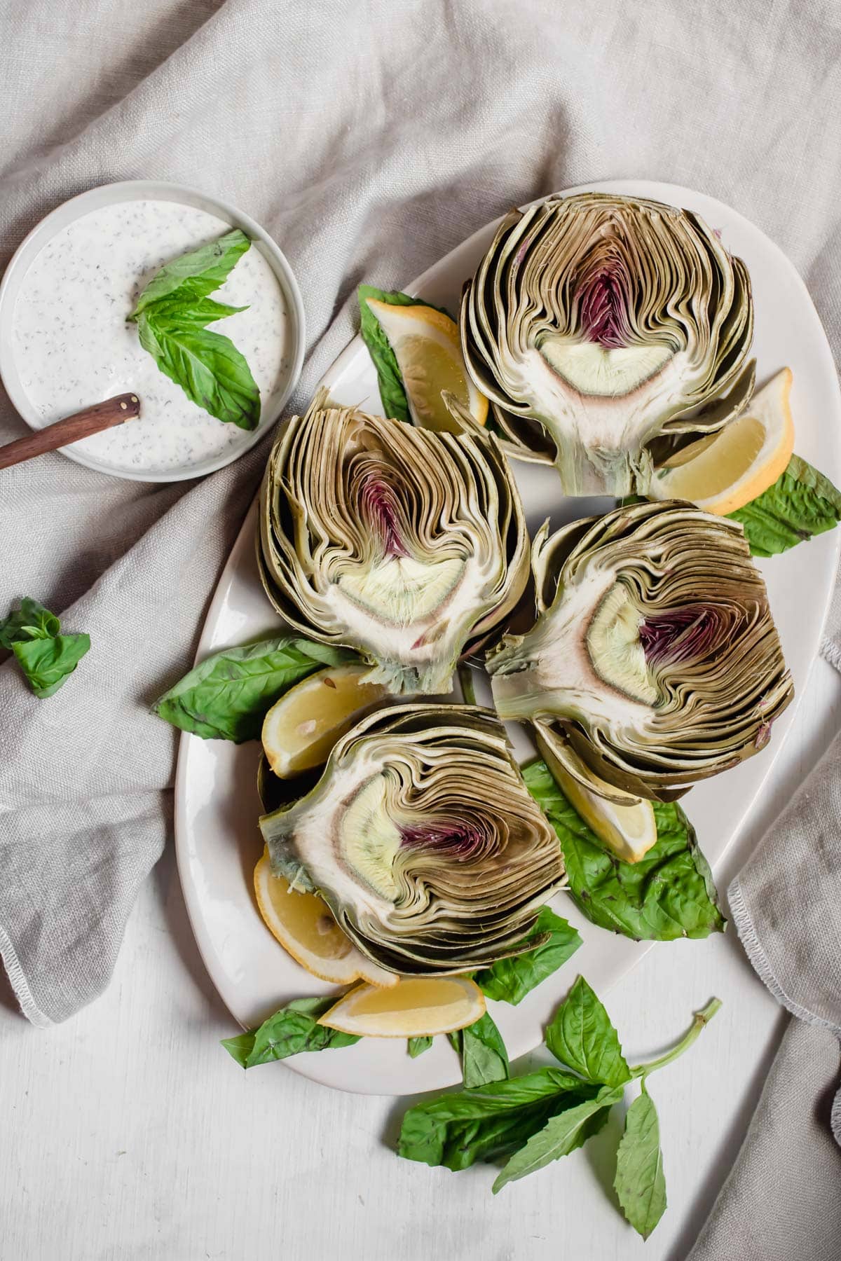 artichokes and dip on a plate
